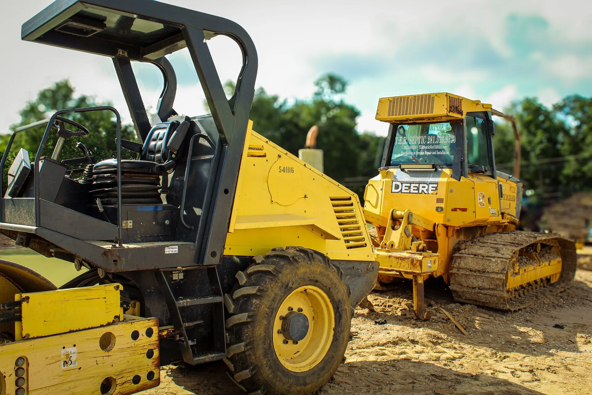 Bulldozer and roller working a Greater Houston site