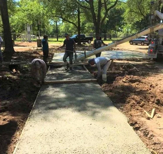 Crew pouring and finishing a new concrete walkway in Tomball, TX