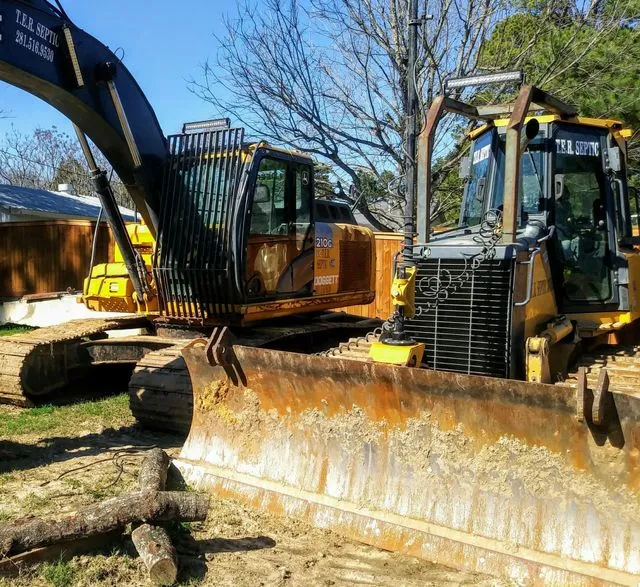 Excavators and bulldozers performing site preparation and earthmoving.